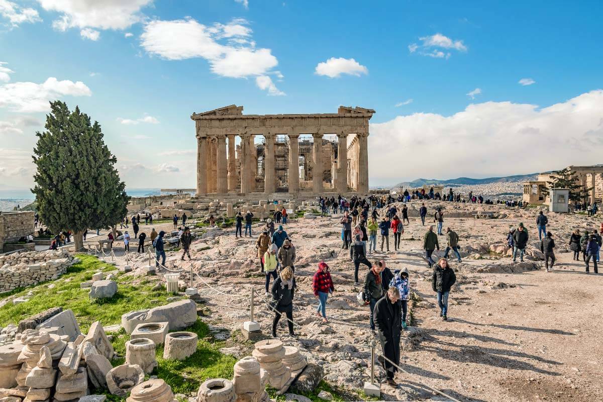 tourists during a tour in front of the Parthenon