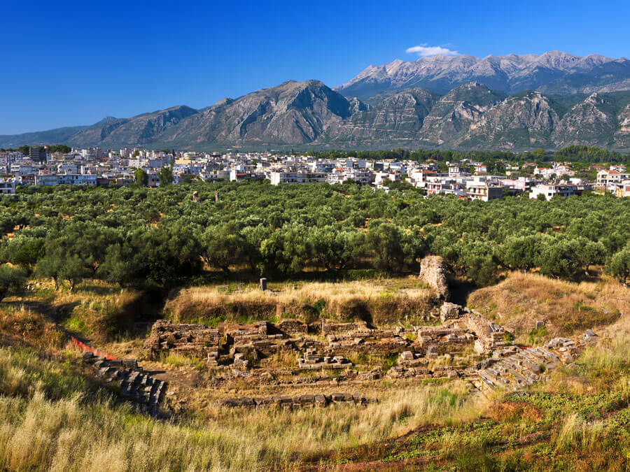 Credit: WitR / Shutterstock Remains of ancient Sparta, ruins of theater. The modern city and fragment of the Taygetus mountain in the background