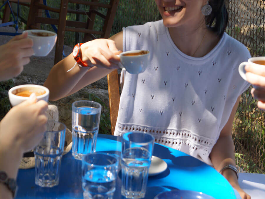 Credit: Greek TravelTellers Friends enjoying Greek coffee during a food tour in Athens